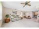 Inviting living room area featuring a sofa, decorative artwork, and seamless flow into the dining space at 12156 Meadowbrook Ln, Largo, FL 33774
