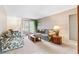 Bright living room featuring comfortable seating, carpeted floors, and a large window at 12156 Meadowbrook Ln, Largo, FL 33774