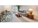 Bright living room featuring comfortable seating, carpeted floors, and a large window at 12156 Meadowbrook Ln, Largo, FL 33774