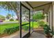 View from the screened-in front porch, showcasing the well-maintained front yard and neighborhood at 12156 Meadowbrook Ln, Largo, FL 33774