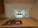 View from the kitchen into the living area boasting natural light and an open concept at 12300 Vonn Rd # 9105, Largo, FL 33774