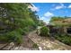 Expansive backyard with lush greenery, mature trees, and a charming garden path at 12411 Talpa St, Spring Hill, FL 34608