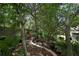 Tranquil backyard featuring brick-lined pathway with lush greenery and shaded seating area at 12411 Talpa St, Spring Hill, FL 34608