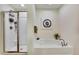 Bright bathroom featuring a soaking tub, framed artwork, and glass shower with shower caddy for storage at 12411 Talpa St, Spring Hill, FL 34608