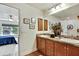 Bathroom with double sinks, granite countertop, wood cabinets, framed art, decorative mirror, and view to bedroom at 12411 Talpa St, Spring Hill, FL 34608