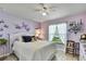 Charming bedroom with lavender walls, decorative butterflies, and a comfortable white bed at 12411 Talpa St, Spring Hill, FL 34608
