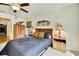 Bedroom features a ceiling fan, decorative headboard and a large dresser at 12411 Talpa St, Spring Hill, FL 34608