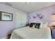 Comfortable bedroom with butterfly wall decor, plush bedding, and a serene, inviting atmosphere at 12411 Talpa St, Spring Hill, FL 34608