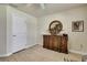 Bedroom with wooden floors, wooden dresser, round mirror, and decorative art at 12411 Talpa St, Spring Hill, FL 34608