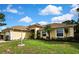 Charming home exterior features a well-maintained lawn and tasteful landscaping at 12411 Talpa St, Spring Hill, FL 34608