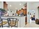 Well-lit kitchen boasts granite counters, breakfast bar, and views into the adjacent bedroom at 12411 Talpa St, Spring Hill, FL 34608
