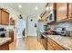 Open kitchen features granite counters, stainless appliances and hardwood flooring at 12411 Talpa St, Spring Hill, FL 34608