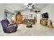 Inviting living room featuring vaulted ceilings, tile floors and ample natural light from large windows at 12411 Talpa St, Spring Hill, FL 34608
