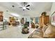 Bright open concept showing the living room with vaulted ceilings leading to the dining room and kitchen at 12411 Talpa St, Spring Hill, FL 34608