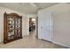 Living room with wood floors, open doorway and dining room view, and glass display case at 12411 Talpa St, Spring Hill, FL 34608