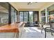 Cozy sunroom featuring tile flooring and abundant natural light with peaceful backyard view at 12411 Talpa St, Spring Hill, FL 34608