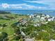 Scenic aerial view of waterfront property featuring lush golf course and coastal buildings at 125 Belleview Blvd # 503, Belleair, FL 33756
