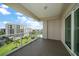 Spacious balcony with glass railings overlooking manicured lawns, a pool, and other buildings at 125 Belleview Blvd # 503, Belleair, FL 33756