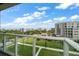 Scenic balcony view of landscaped grounds, nearby buildings, and glimpses of the water at 125 Belleview Blvd # 503, Belleair, FL 33756