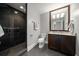 Contemporary bathroom features a walk-in shower with dark tile and modern fixtures at 125 Belleview Blvd # 503, Belleair, FL 33756