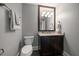 A well-lit half bath with a dark wood vanity and marble countertop at 125 Belleview Blvd # 503, Belleair, FL 33756