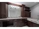 A spacious bathroom features dark wood cabinets, a marble countertop, and an oversized mirror at 125 Belleview Blvd # 503, Belleair, FL 33756