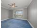 This carpeted bedroom has a ceiling fan and a large window with plantation shutters at 125 Belleview Blvd # 503, Belleair, FL 33756