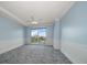 Bright and airy bedroom showcasing decorative molding and a sliding door to a balcony with city views at 125 Belleview Blvd # 503, Belleair, FL 33756