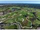 Aerial shot of a beautiful golf course with intricate layouts, sand traps, and palm tree-lined fairways at 125 Belleview Blvd # 503, Belleair, FL 33756