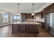 Kitchen island with stainless steel appliances, granite counters, and hardwood floors at 125 Belleview Blvd # 503, Belleair, FL 33756