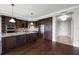 Spacious kitchen featuring dark wood cabinetry, stainless steel appliances, and a granite-topped island at 125 Belleview Blvd # 503, Belleair, FL 33756