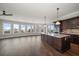 Open living room and kitchen featuring hardwood floors and natural light at 125 Belleview Blvd # 503, Belleair, FL 33756