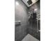 A modern shower with dark gray tile and dual shower heads at 125 Belleview Blvd # 503, Belleair, FL 33756