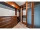 This walk-in closet offers plenty of storage space with custom dark wood shelving at 125 Belleview Blvd # 503, Belleair, FL 33756