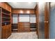 A spacious walk-in closet with custom dark wood shelving and storage at 125 Belleview Blvd # 503, Belleair, FL 33756