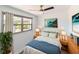 Bright bedroom showcasing a cozy bed, stylish decor, and ample natural light from the large window at 1328 Waikiki Way, Tampa, FL 33619