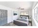 A bright bedroom with a gray bed, ceiling fan, and neutral decor creates a relaxing and inviting atmosphere at 1328 Waikiki Way, Tampa, FL 33619