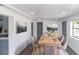 A spacious dining room is furnished with a wood table, chairs, and artwork on the white walls at 1328 Waikiki Way, Tampa, FL 33619