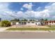 Quaint single-story home featuring a covered parking area and a fenced front yard at 1328 Waikiki Way, Tampa, FL 33619