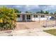 Charming single-story home with a covered parking area and fenced front yard at 1328 Waikiki Way, Tampa, FL 33619