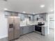Updated kitchen with stainless steel appliances, gray cabinets, and white countertops at 1328 Waikiki Way, Tampa, FL 33619