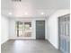 Bright and inviting living room with gray wood floors, modern lighting, and ample natural light at 1328 Waikiki Way, Tampa, FL 33619