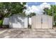 View of two storage sheds providing additional space for tools and equipment on a concrete pad at 1328 Waikiki Way, Tampa, FL 33619