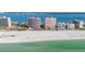 Stunning aerial view of pristine beach and luxurious beachfront highrise condos with gorgeous turquoise water views at 1340 Gulf Blvd # 16F, Clearwater, FL 33767