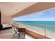 Spacious balcony with comfortable seating and expansive views of the ocean and beach at 1340 Gulf Blvd # 16F, Clearwater, FL 33767