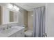 Well-lit bathroom with a shower-tub combination and a modern vanity for everyday convenience at 1340 Gulf Blvd # 16F, Clearwater, FL 33767