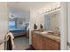 Bathroom showcasing double sinks with granite countertops and a peek into the bedroom at 1340 Gulf Blvd # 16F, Clearwater, FL 33767