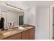 Bathroom featuring double sinks, granite counters, and white cabinets at 1340 Gulf Blvd # 16F, Clearwater, FL 33767