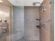 Modern bathroom features a tiled shower with dual shower heads and decorative tiled accents at 1340 Gulf Blvd # 16F, Clearwater, FL 33767