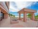 Beachfront view of the sheltered barbecue grill with palm trees and the ocean in the background at 1340 Gulf Blvd # 16F, Clearwater, FL 33767